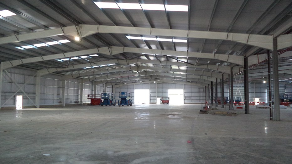 British Army fleet hub warehouse with hydraulic scissor lifts in the background