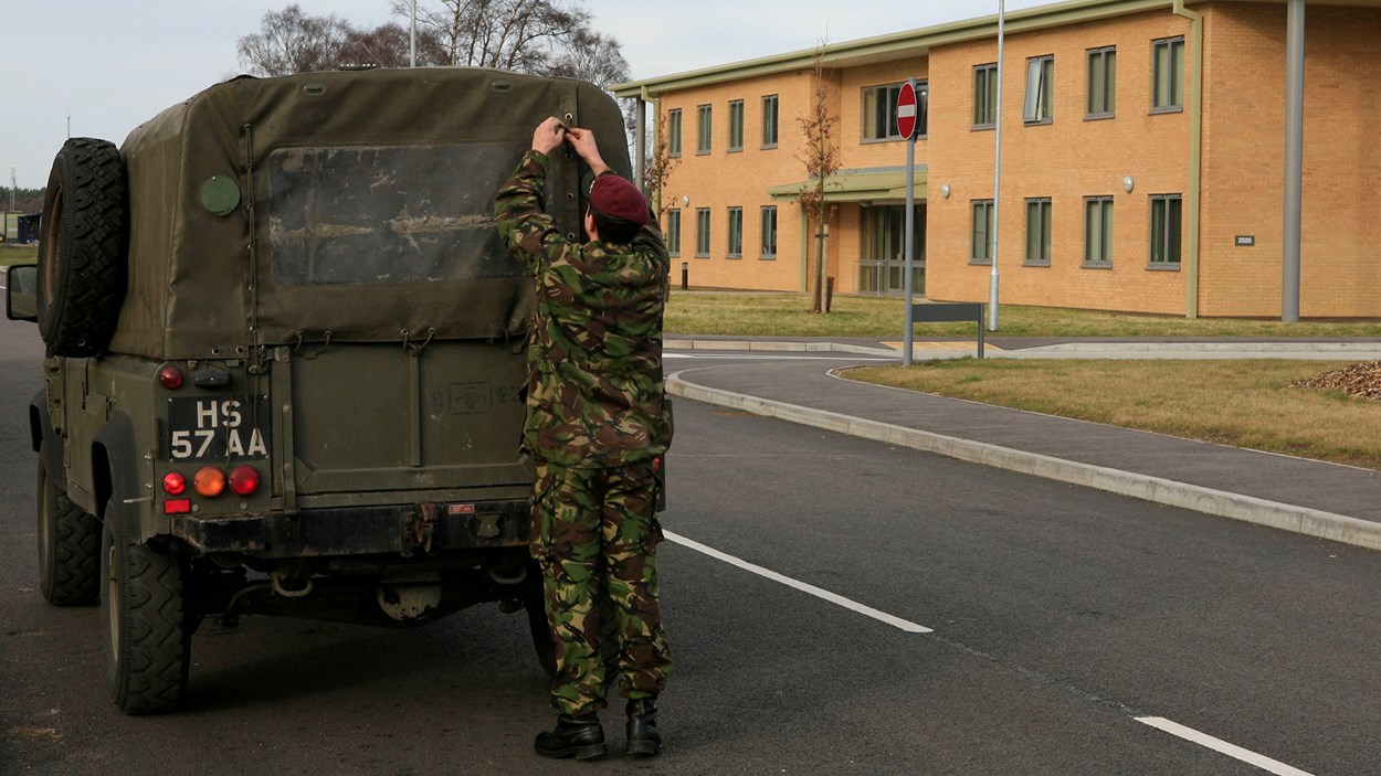 A soldier at a military base, built by Skanska