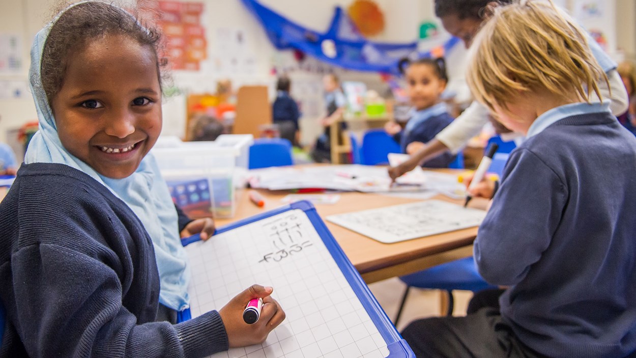 A happy girl at in a primary school class