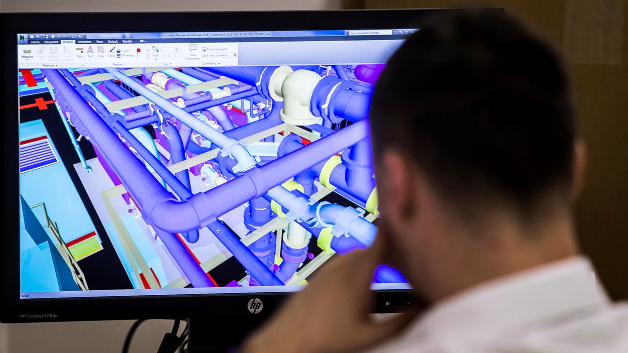 A Skanska engineer looks at a 3D model of a project  on a computer