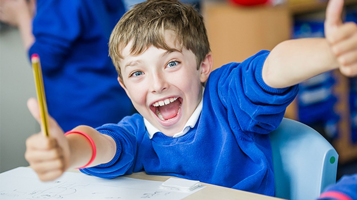 A happy child at a primary school in Bristol, refurbished by Skanska