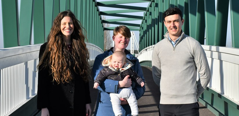 From left to right: Terri Seel, Esther Redpath with baby and Adam Gallis on the new A45 footbridge