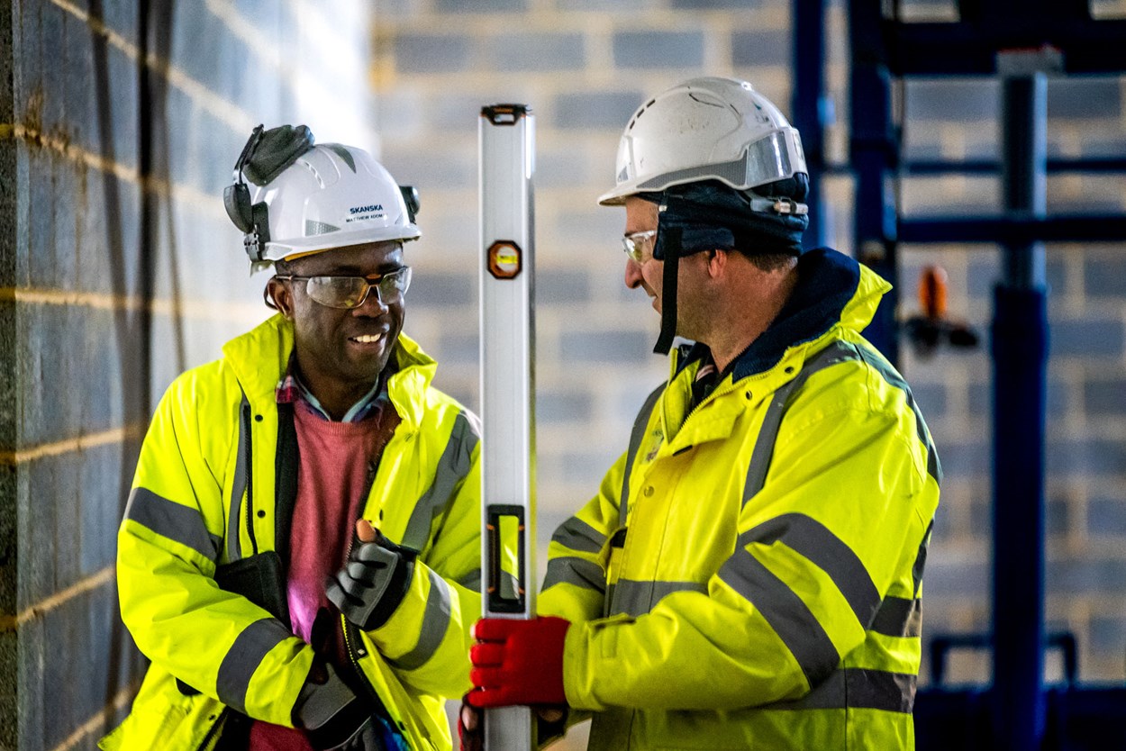 Two Skanska construction workers talking to each other at Worthy Down, a major project for the Ministry of Defence