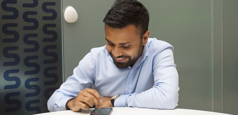 Ruhul Amin from Technical Services uses the Spaceti mobile app, with one of the sensors in the background Ruhul Amin from Technical Services uses the Spaceti mobile app, with one of the sensors in the background