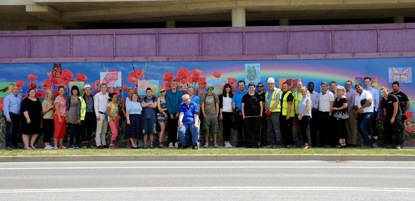 Red2Green charity people and AstraZeneca project workers admire the award-winning hoardings. Red2Green charity people and AstraZeneca project workers admire the award-winning hoardings.
