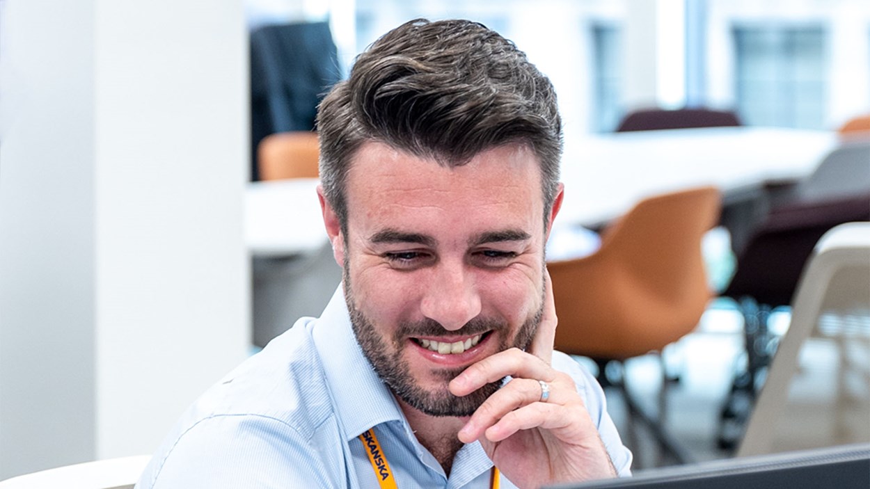 A happy man, working at this desk