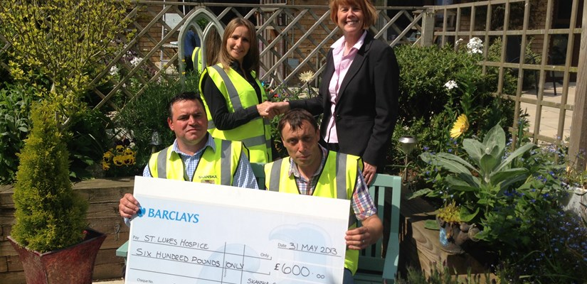 The team working on the new Woodlands School hands over the cheque to St Lukes Hospice