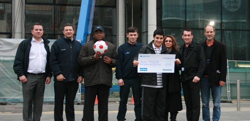 Nahil and Joel collect the cheque on behalf of Brent Mencap